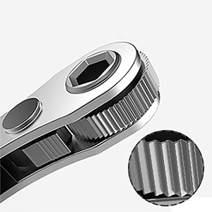 Close-up of a metallic ratchet mechanism, showing a grooved wheel and a lever or pawl. The image is in black and white.