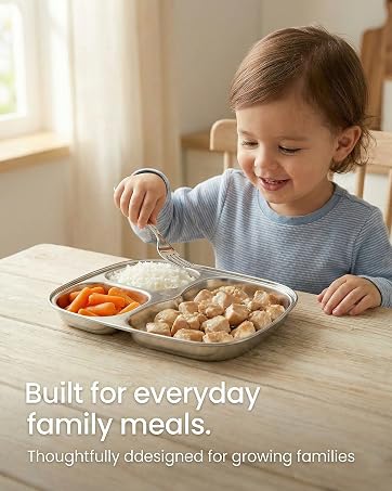 Child enjoying a meal with a 3-compartment stainless steel tray filled with simple foods.