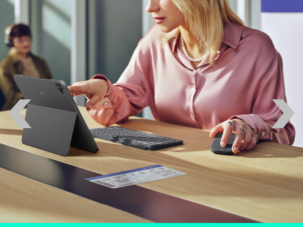 a woman holding a foldable mouse