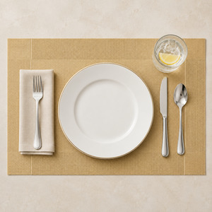 Full dinner setting arranged on a champagne gold rectangular placemat