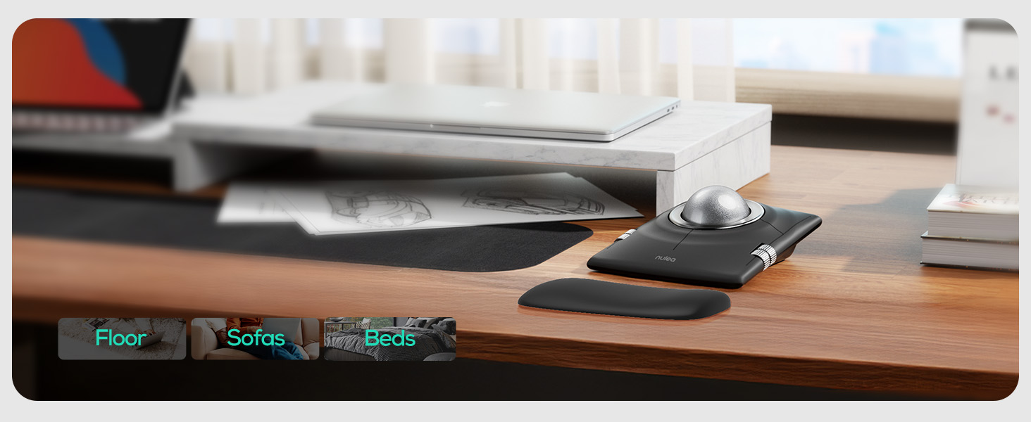 Text reads 'Floor', 'Surface', and 'Non-Stick'. Desktop workspace showing electronic devices and accessories on wooden surface.