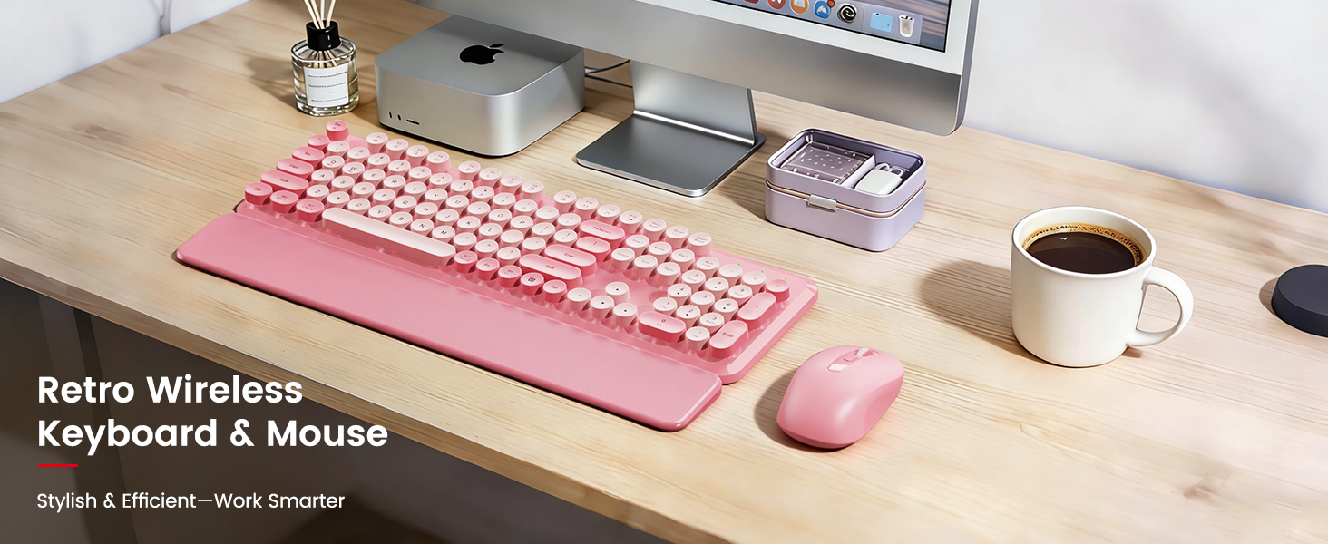 Blush Pink retro wireless keyboard and mouse with detachable wrist rest on a wooden desk