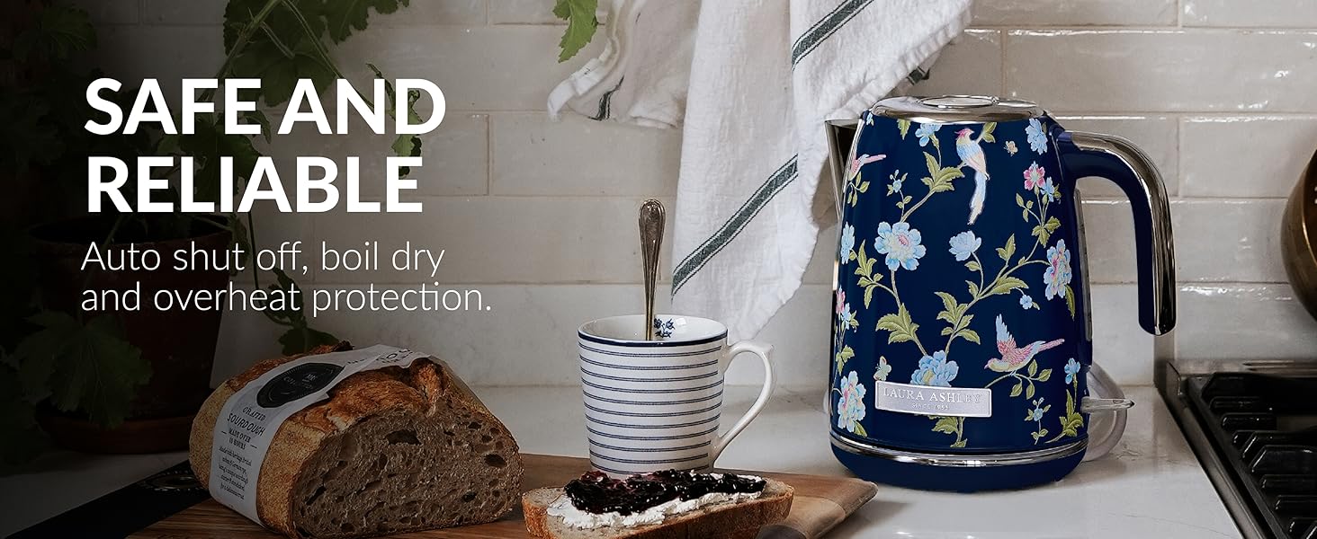 Tea or coffee brewing setup with dark blue patterned teapot and kitchen items arranged on light colored surface with decorative styling.