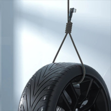 The cable tied in a loop and holding a car wheel