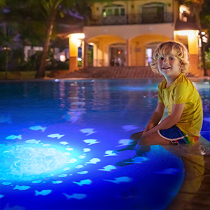 a child sits in a pool at night