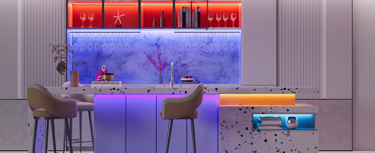 Modern kitchen island with color-changing LED backlighting, featuring bar seating, decorative glassware display, and a sleek countertop with integrated appliances.
