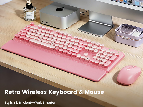 Blush Pink retro wireless keyboard and mouse with detachable wrist rest on a wooden desk