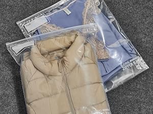Showing how much can fit in a slider big bag by storing away seasonal clothes