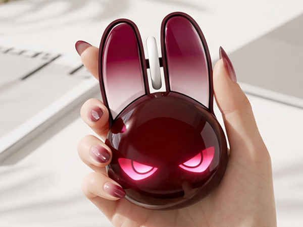 Full-frame studio shot of the rabbit-shaped wireless mouse in gradient burgundy, centered against a
