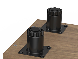 Two black cylindrical furniture legs with adjustable height mechanisms, mounted on square metal plates attached to a wooden surface.