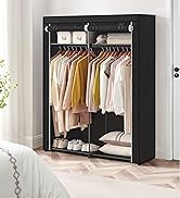 Portable fabric wardrobe with black cover. Features hanging rod, shelves, and storage boxes. Contains assorted clothing and shoes.