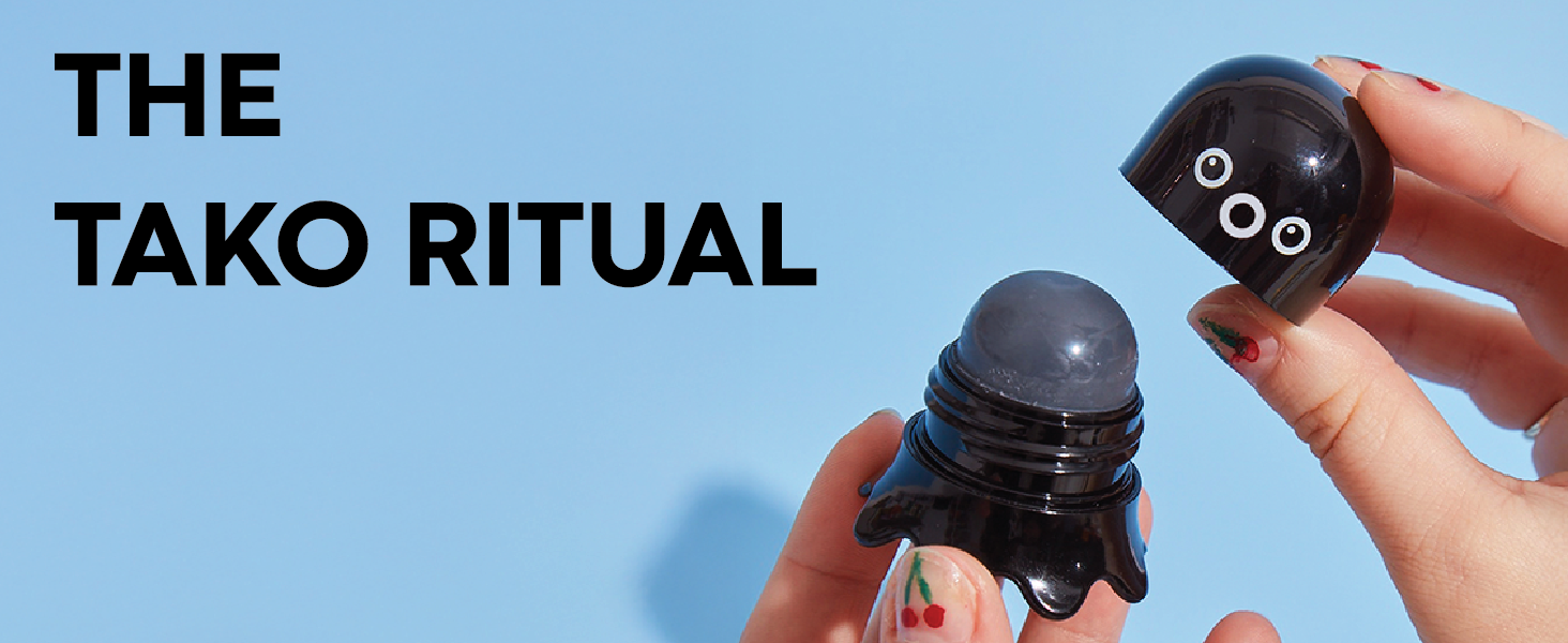 Hands opening the Tako Pore Scrub Stick on a blue background beneath "The Tako Ritual" headline