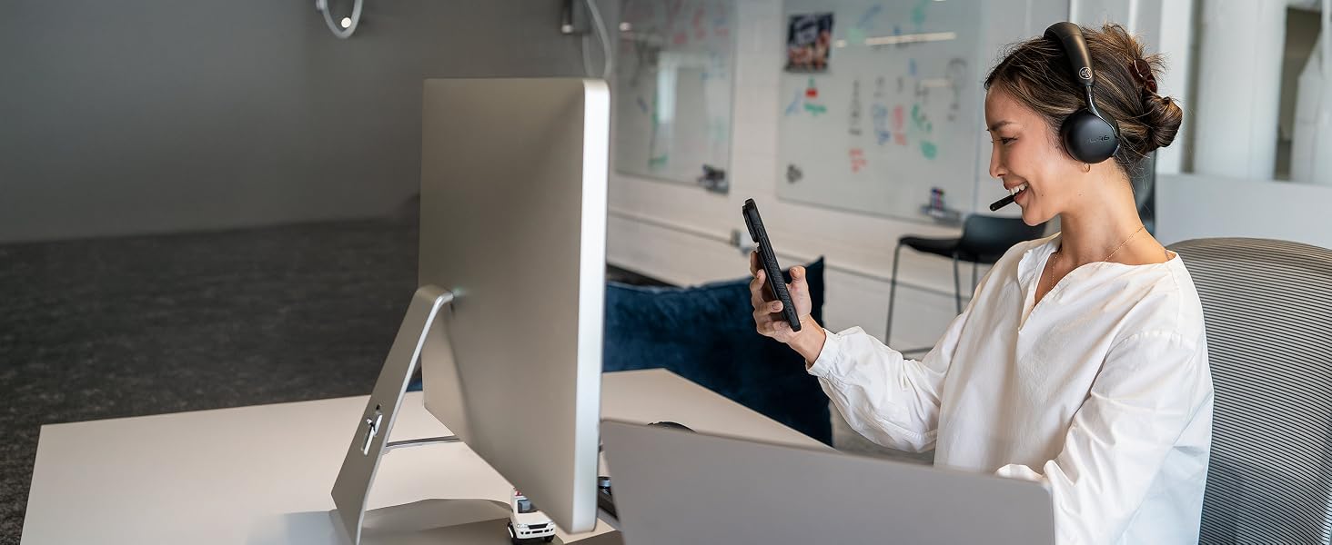 A woman using go work 3 headset with multiple devices