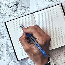 Pen shows person travel-journaling with the G2 Fine pen