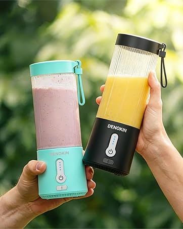 Hands holding colorful insulated beverage containers or water bottles in outdoor setting with sunlit foliage in background.