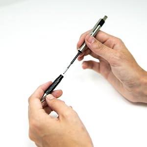 Zebra Pen F Series ink replacement refill being installed in a steel pen, ballpoint
