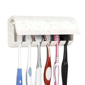 White wall-mounted toothbrush holder with suction cup, featuring multiple slots holding five toothbrushes in various colors: blue, white, red, pink, and black.