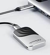 Portable external hard drive with USB cable connected to a laptop. Silver and black device with rounded edges and a sleek design.