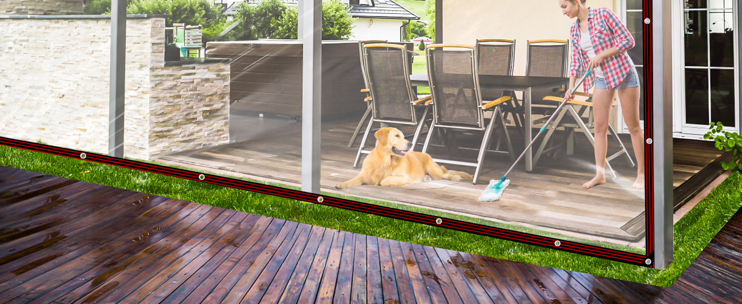 Glass-enclosed porch or deck space with wood flooring, featuring modern outdoor furniture and transparent safety barriers.