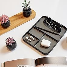 black valet tray with some plants and an open book