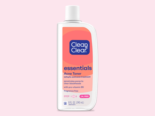 bottle of Clean & Clear Essentials Acne Toner on coral colored background