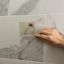 Hand gripping the non-adhesive edge of a HairStixies pad