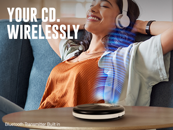 Woman wirelessly listening to the RETRO-30 CD Bluetooth player while relaxing on a couch.