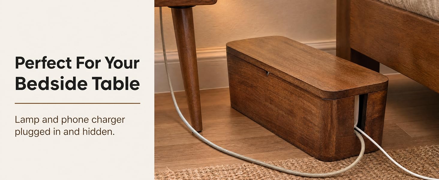 Mango wood cable box by a nightstand holding a phone charger and lamp cord