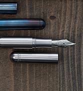 Multiple detailed views of metallic writing instruments or tools against a dark wooden background, showing various angles and components.