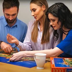 Friends assembling jigsaw puzzles