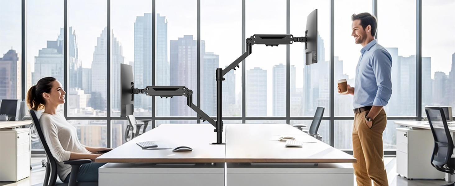 Contemporary open office space with floor-to-ceiling windows, showing people working at standing desks in a bright, airy environment.