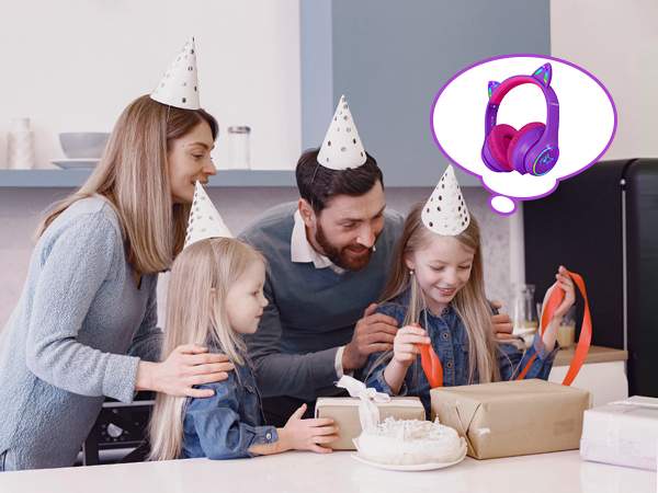 Birthday celebration scene with opened package, party hats, and thought bubble showing purple wireless headphones.