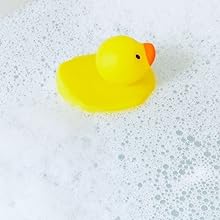 Rubber duck in bathtub with bubbles