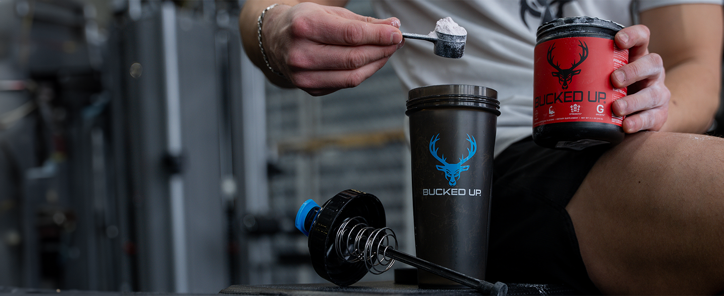 Man pouring scoop of Bucked Up Pre-workout into a Bucked Up Perfect Shaker bottle