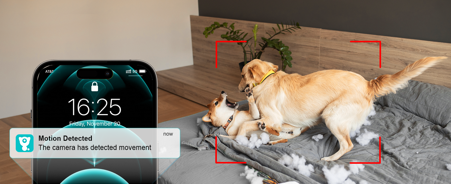 a couple of dogs on a bed with a smart phone in the background.