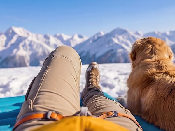 POV relaxing on Airlive2000 pad with dog, snowy peaks ahead.