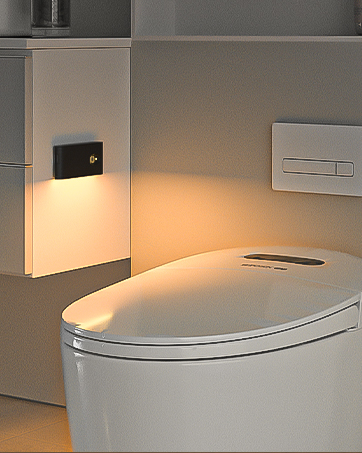 Modern white elongated toilet with ambient lighting and electronic control panel mounted on wall.
