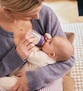 Woman Feeding Baby With Lansinoh Baby Bottle