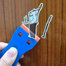 use scraper to remove sticker on the wood