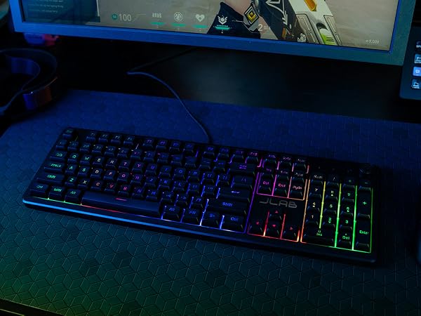 Nightfall gaming keyboard on a gaming pad with a monitor in the background