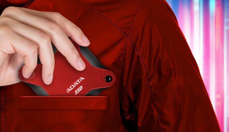 a man putting red SD600Q SSD into the top pocket of his shirt