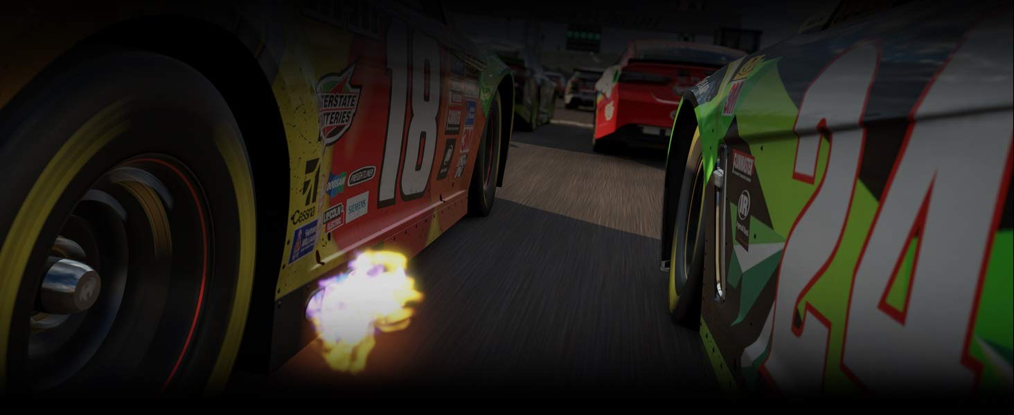 Closeup Shot of RaceCars Speeding on a Track with Fire Coming from the Exhaust of One Car
