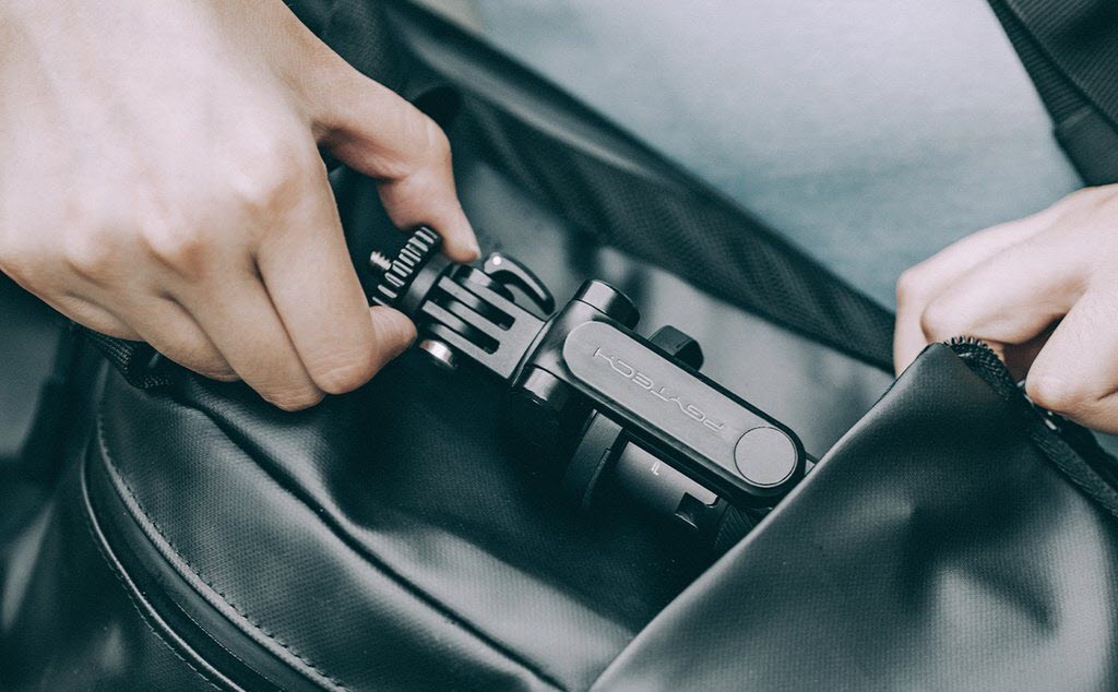 a man putting his right hand into the lanyard of PGYTECH Protective Case