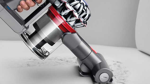 of Dyson V7 Absolute in handheld mode cleaning hair on the couch