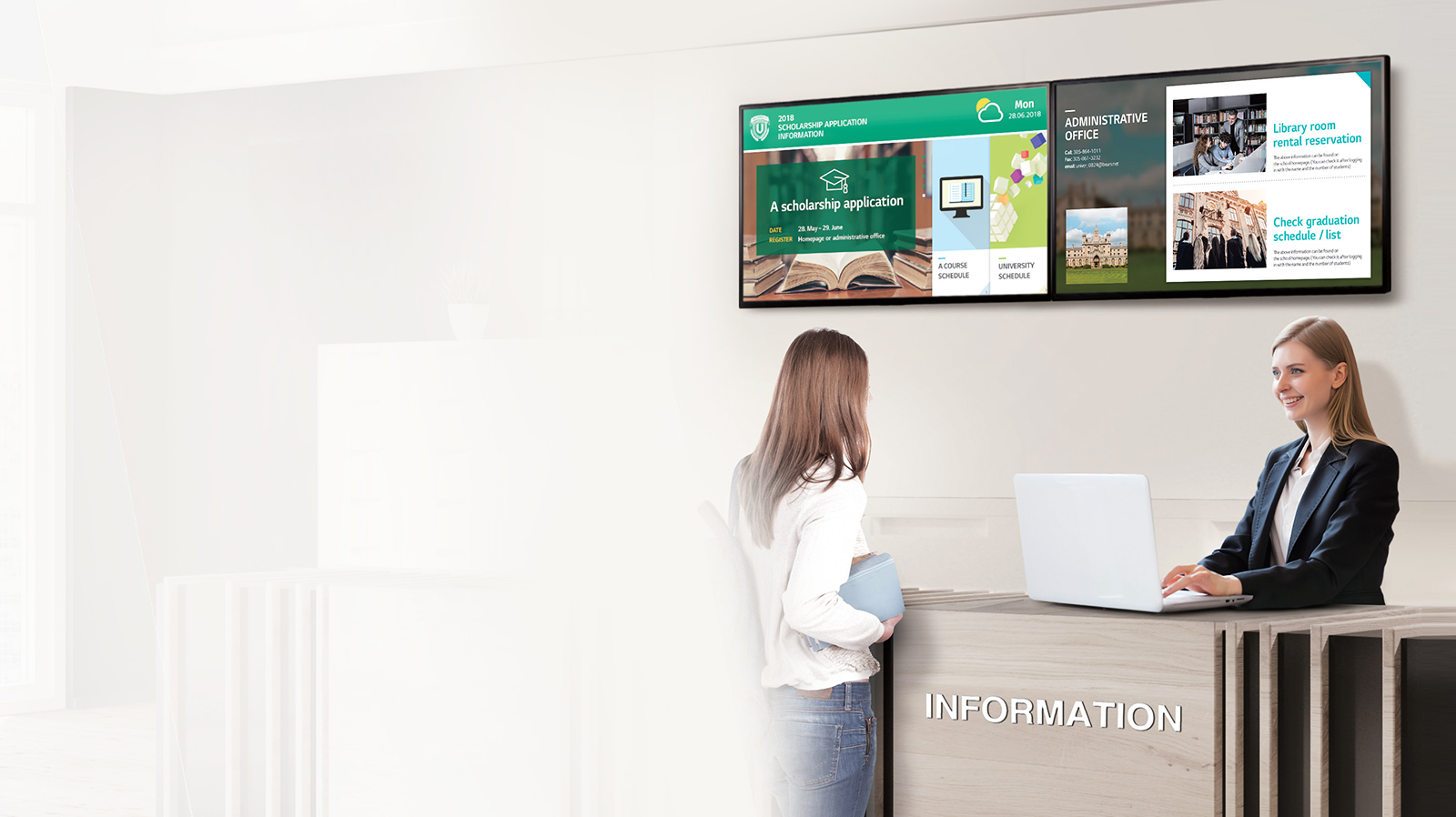 Two LG commercial displays mounted behind an information kiosk that two women are at