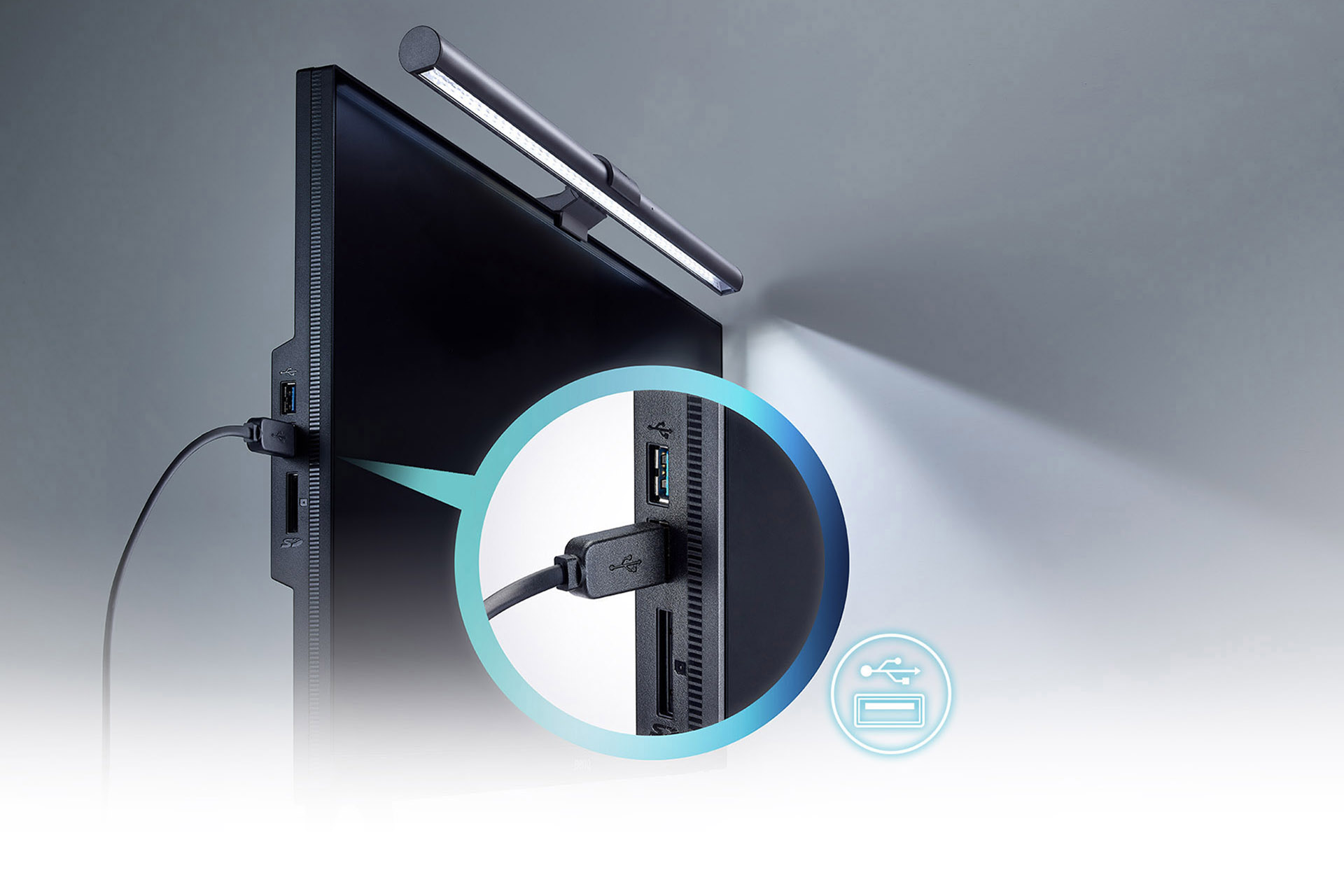 BenQ ScreenBar Plus mounted a mounter that's angled to the right with a USB cable plugged to the side of the monitor