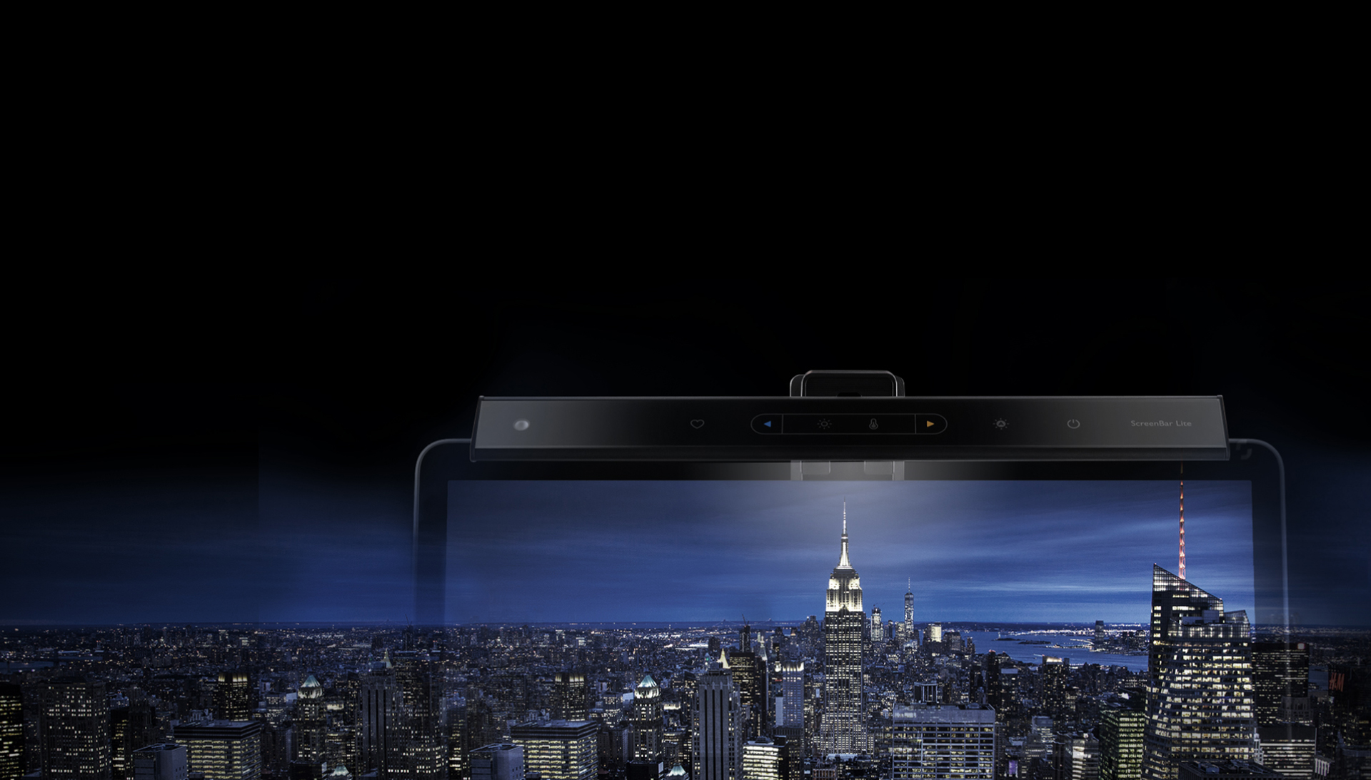 BenQ ScreenBar Lite mounted on a screen that's blending with the background image of a city skyline at night