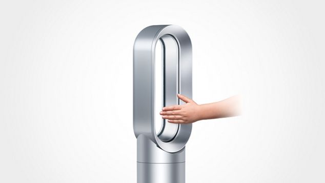 a hand reaching into Dyson AM09 Fan Heater