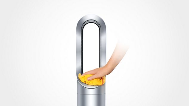 a hand cleanning Dyson AM09 Fan Heater with a yellow towel