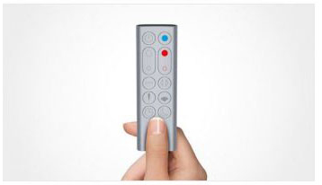 A hand is holding the remote control